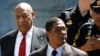 Actor and comedian Bill Cosby, left, exits Montgomery County Courthouse after a jury convicted him in a sexual assault retrial in Norristown, Pennsylvania, April 26, 2018. 