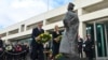Australian Prime Minister Anthony Albanese, center left, and Minister for Finance Katy Gallagher lay a wreath at the statue of Queen Elizabeth II at Parliament House in Canberra, Sept. 10, 2022. (Mick Tsikas/AAP Image via AP) 