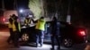 Police officers gather outside a grain depot in Przewodow, eastern Poland, where a blast that killed two people was reportedly caused by a stray Russian missile on Nov. 15, 2022. Russia has denied the allegation.