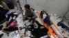 FILE - Wounded Palestinians are assisted at Nasser hospital, following Israeli strikes on Ma'an school east of Khan Younis, in Khan Younis in the southern Gaza Strip, Dec. 5, 2023.