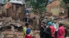 People stand by the damage in the aftermath of deadly floods caused by torrential rains in Bukavu, Democratic Republic of Congo, Dec. 27, 2023.