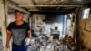 A resident of Vina de Mar, Chile, stands in his home that burned when forest fires that broke out three days earlier reached his neighborhood, Feb. 5, 2024. 