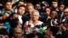 Bangladeshi Nobel peace laureate Professor Muhammad Yunus gestures in front of the court after being sentenced for six months of imprisonment and fined BDT 5,000 in a labor law violation case, in Dhaka, Bangladesh, Jan. 1, 2024. 