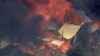 This image made from video shows home engulfed in flames outside Perth, Australia, Dec. 21, 2023.