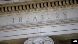 FILE- The U.S. Treasury Department building is shown at dusk in Washington.