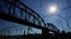FILE - The Union Pacific International Railroad Bridge is seen behind concertina wire, Sept. 22, 2023, in Eagle Pass, Texas. 
