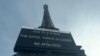 A board informs visitors that the site is closed after staff went on strike, at the bottom of the Eiffel Tower in Paris, Dec. 27, 2023.