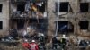 Firefighters work at the site of a residential building damaged during a Russian missile attack in Kyiv, Ukraine, Jan. 2, 2024