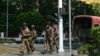 Members of the Myanmar's military security force patrol a street during a "silent strike" to protest and to mark the third anniversary of the military coup in Yangon, Feb. 1, 2024.