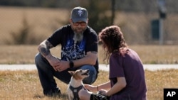 Dusty Farr talks with his daughter in a park near Smithville, Missouri, Feb. 25, 2024. Farr is suing the Platt County School District after his daughter was suspended for using the girls' bathroom at the high school she attended.