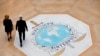 FILE - People walk on the Interpol logo at the international police agency headquarters in Lyon, central France, Nov. 8, 2018. 