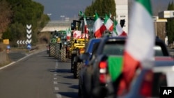 Farmers line up with their tractors on the high speed road in Orte, Italy, Jan. 31, 2024. 