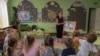 A teacher leads a class about mine safety in a kindergarten in Kryvyi Rih, Ukraine, Sept. 14, 2023. Teachers, along with civil servants and pensioners, could see delayed pay if Western aid to the country is not approved soon, officials say. 