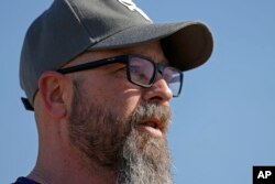 "Being a teenager is hell," says Dusty Farr, pictured Feb. 25, 2024, near Smithville, Missouri. "Being a trans teen is 10 kinds of hell." He says his daughter, who is transgender, "is the brave one. I'm just her voice."