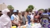 Philomena Irene, UNICEF nutrition specialist, speaks to women about food that will boost nutrient intake, in Kaltungo Poshereng, Nigeria, June 2, 2024. UNICEF said June 6 that one in four children under age 5 worldwide is experiencing severe food poverty.