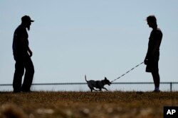 Dusty Farr talks with his daughter at a park near Smithville, Missouri, Feb. 25, 2024. Farr is suing the Platt County School District after his daughter, who is transgender, was suspended for using the girls' bathroom at the high school she attended.