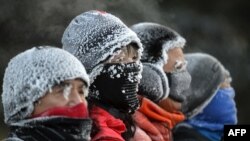 Residents are covered in frost while exercising outdoors in Shenyang, in China's northeast Liaoning province, Dec. 20, 2023. It's not as frosty well to the south, but even Shanghai is experiencing an unusual cold spell.
