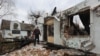 A man stands next to the museum dedicated to Roman Shukhevych, leader of the Ukrainian Insurgent Army (UPA), which was destroyed by a Russian drone strike, amid Russia's attack on Ukraine, in Lviv, Ukraine, Jan. 1, 2024. 