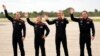 From left, astronauts Marcus Wandt of Sweden, Alper Gezeravci of Turkey, Walter Villadei of Italy and Michael Lopez-Alegria of Spain and the U.S. wave at the Kennedy Space Center, Jan. 18, 2024, in Cape Canaveral, Fla.