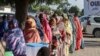 Women queue to cast their votes during the constitutional referendum at a polling station in N'Djamena, Dec. 17, 2023. 