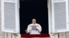 Pope Francis leads the Angelus prayer from his window, in St. Peter's Square at the Vatican, Dec. 24, 2023. 