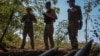 Ukrainian servicemen stand near artillery shells at a front line in Donetsk region, Ukraine, Sept. 22, 2023. Ukraine officials said on December 22 that they had uncovered a plot that involved the fraudulent purchase of shells and included the embezzlement of $40 million.
