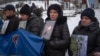 FILE - Relatives of Ukrainian soldiers who were captured by Russia hold their photos demanding they be freed, at a rally in central Kyiv, Ukraine, Dec. 10, 2023.