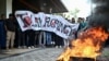Indonesian protesters burn a tire during a protest for the deportation of the Rohingya refugees in Banda Aceh, Aceh province, Dec. 27, 2023. 