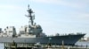 FILE - The USS Mason, an Arleigh Burke-class destroyer, passes a dock in Norfolk, Va., April 8, 2021. 