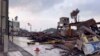 In this image from video provided by Yoshie Minamidani, a yellow tape blocks a street after a powerful earthquake in Wajima, Ishikawa prefecture, Japan, Jan. 2024. (Yoshie Minamidani via AP)
