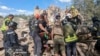 Emergency workers clear rubble as they search for victims after a Russian missile hit the area, in Kryvyi Rih, Ukraine, June 12, 2024. (Ukrainian Emergency Service via AP)