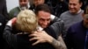 Spanish national Santiago Sanchez embraces his mother upon his arrival at Adolfo Suarez Madrid-Barajas Airport in Madrid, Spain, Jan. 2, 2024, after his release from an Iranian prison.