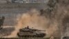An Israeli army tank moves near the Gaza Strip border, in southern Israel, Dec. 23, 2023. 