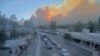 In this image taken from webcam footage provided by the Village of Ruidoso, smoke rises behind Ruidoso, NM, on June 17, 2024. 
