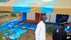 Exhumed bodies of victims of a religious cult are laid out in the village of Shakahola, near the coastal city of Malindi, southern Kenya, April 23, 2023.