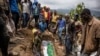 Relatives lay to rest two members of the Haringo family at a cemetery close to the scene of a landslide in Kencho Shacha Gozdi on July 26, 2024. 