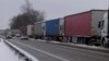FILE - Trucks line up in a long queue to cross the Polish-Ukrainian border at the Dorohusk-Jagodzin crossing, in Okopy, Poland, Dec. 4, 2023.