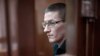 Robert Woodland, a Russia-born U.S. citizen, stands in a glass cage during a court hearing, July 4, 2024, in Moscow, Russia.