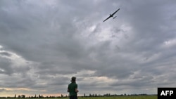 An operator controls a reusable airstrike drone called Punisher made by the Ukrainian company UA Dynamics during a test in Kyiv region on Aug. 11, 2023, amid Russian invasion in Ukraine.