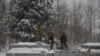 FILE - Ukrainian soldiers rest as they construct shelters for new defensive line, amid Russia's attack on Ukraine, near Belarus border in Chornobyl exclusion zone, Ukraine, Dec. 14, 2023.