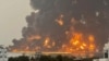 A handout picture obtained from Yemen's Huthi Ansarullah Media Center shows a huge column of fire erupting following strikes in the Yemeni rebel-held port city of Hodeidah on July 20, 2024. 