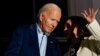 Vice President Kamala Harris speaks with President Joe Biden on a White House balcony during an Independence Day celebration in Washington, July 4, 2024. 