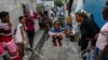 FILE - A girl jumps rope at a school housing residents displaced by gang violence in Port-au-Prince, Haiti, May 15, 2024.