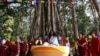 FILE - Ram Bahadur Bamjan, center in white, is surrounded by Buddhist monks in Nijgadh town, south of Katmandu, Nepal, Nov. 12, 2008. 