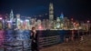 FILE - A man talks on his phone against the backdrop of the skyline in Hong Kong, Oct. 19, 2022.