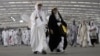 FILE - Iranian pilgrims walk to cast stones at a pillar in the symbolic stoning of the devil, the last rite of the annual Hajj pilgrimage, in Mina near the holy city of Mecca, Saudi Arabia, June 29, 2023.