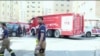 Rescuers arrive at the site of a residential building fire in Kuwait, June 12, 2024. (Kuwait TV via AP)