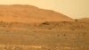 FILE - This April 30, 2021, image taken by the Mars Perseverance rover shows the Ingenuity helicopter, right, flying over the surface of the planet. Data gathered from the rover have confirmed that lake sediments existed on Mars. (NASA via AP)
