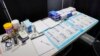 FILE - COVID tests are set up inside the medical intake tent at a shelter in New York on Aug. 15, 2023.