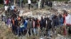 Onlookers gather at the dumpsite where six bodies were found in the landfill in Mukuru slum, Nairobi, July 12, 2024. 